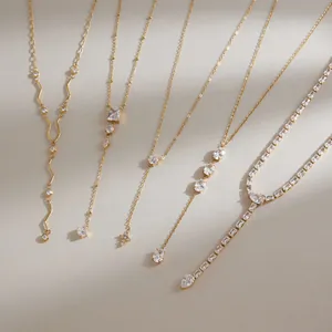 Close-up of gold-plated stainless steel Y-necklaces with sparkling cubic zirconia crystals.