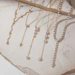 Elegant gold-plated stainless steel necklaces with sparkling zircon lariat designs in macro view.