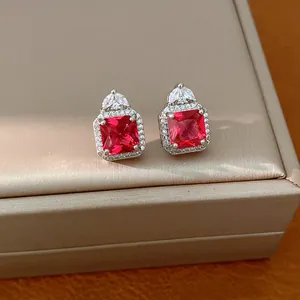Vista dettagliata di eleganti orecchini quadrati con pietra rossa e pavé di zirconi
