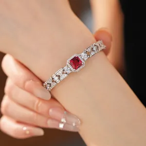 Primo piano di un bracciale in stile reale con zircone rosso e design traforato