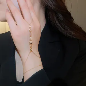 Detailed view of gold plated zircon floral hand chain ring bracelet combo for women
