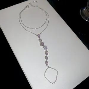 Close-up of 14k gold plated hand harness with pink zircon flower charms