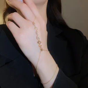 Detailed view of a 14k gold-plated hand harness featuring zircon flower charms.