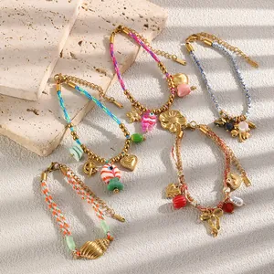 Set of colorful woven rope bracelets featuring 18K gold plated bow and heart charms for women.
