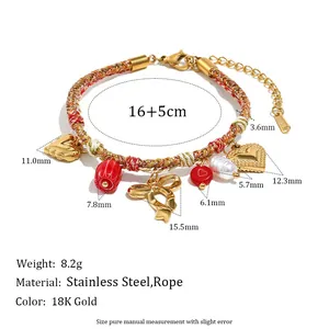 Detailed view of colorful woven rope bracelet with gold-plated heart and bow charms and dimensions