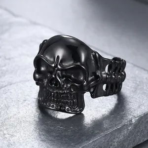 Detail of punk style black titanium steel skull bangle with skeleton bone links.