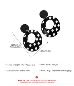 Detail of black and white polka dot acrylic earrings with size measurements