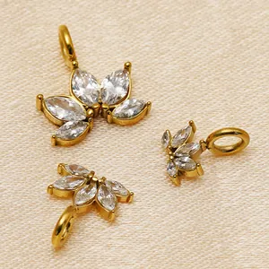 Exquisite macro detail of 14K gold plated 316 stainless steel lotus charms with marquise zircons
