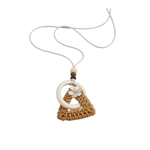 Handmade woven rattan triangle pendant necklace with floral accent and white ring charm