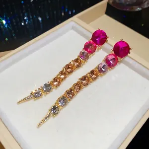 Exaggerated long tassel earrings with pink and amber gradient rhinestones for evening party.