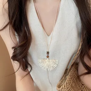 Handmade woven skirt pendant necklace with wood beads and intricate flower detail