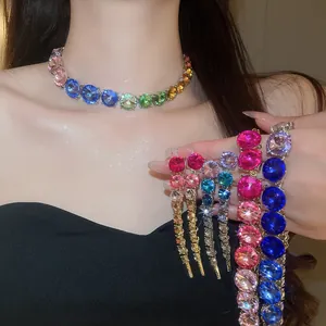 Detailed view of sparkly gradient rhinestone necklace and long tassel earrings jewelry set