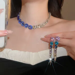 Close-up of gradient crystal necklace and long tassel earrings for evening parties.