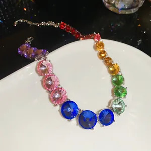Macro detail of a rainbow rhinestone necklace with large round colorful crystals
