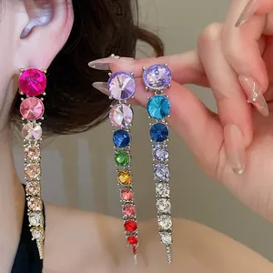 Close-up detail of sparkling multi-color round gradient rhinestone tassel earrings for party