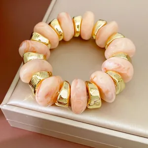 Elegante perzik gemarmerde acryl kralen armband met onregelmatige gouden geometrische verdelers