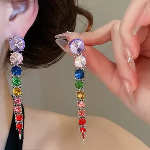 Close-up of rainbow gradient crystal tassel earrings for elegant evening parties