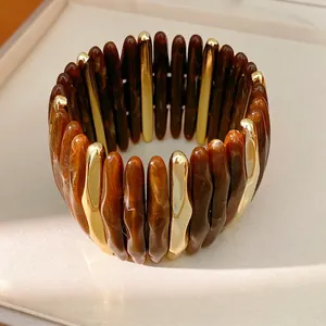 Wide acrylic marbled elastic bracelet with gold segments for a light luxury look