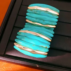 Close-up of turquoise marbled acrylic stretch bracelet with gold metal accents
