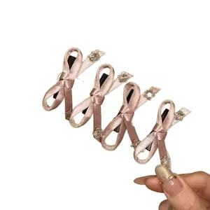 French vintage style pink fabric bow hair clips with rhinestone accents for women and girls.