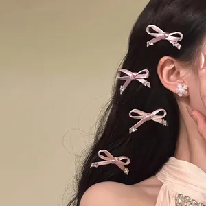 Elegant close-up of pink satin bow hair clips with rhinestones worn on model side hair