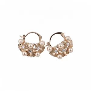 French vintage hollow flower basket earrings with pearls and crystals on white background.