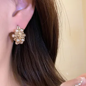 Detailed macro shot of elegant French vintage pearl flower basket earrings on ear
