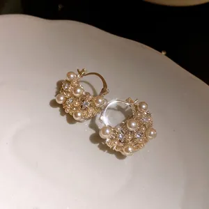 Close-up of vintage French style pearl flower basket hoop earrings with sparkling crystals