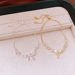 Close-up of elegant zircon bowknot adjustable bracelets in gold and silver finishes.