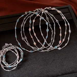 Detail view of woven mesh necklaces and bracelets with colorful dopamine candy beads
