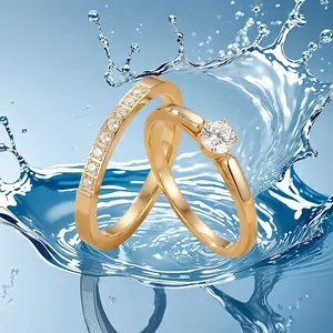 Détail de bagues de mariage en acier doré avec oxydes de zirconium dans l'eau