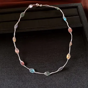 Vibrant dopamine style necklace featuring colorful candy-like beads on a black display tray.