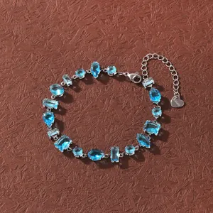 Detailed view of aquamarine cubic zirconia bracelet in stainless steel setting