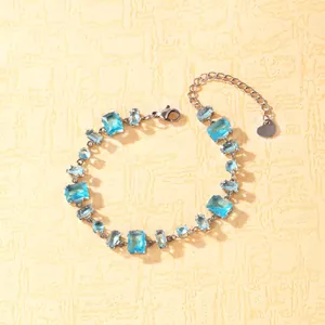 Close-up of stainless steel bracelet with multifaceted blue zirconia and heart charm