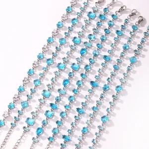 Close-up detail of adjustable stainless steel bracelets with multi-cut aquamarine zircons