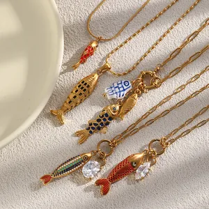 Vista detallada de collares de peces en acero chapado en oro de 18K con esmalte de colores