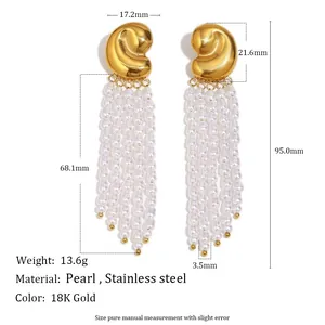 Macro view of 18K gold plated stainless steel stud earrings with elegant pearl tassel drop