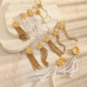 Detail view of Bohemian 18K gold plated stainless steel pearl and flower tassel earrings.