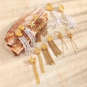 Detailed view of various gold-plated Bohemian earrings with pearls and long tassels.