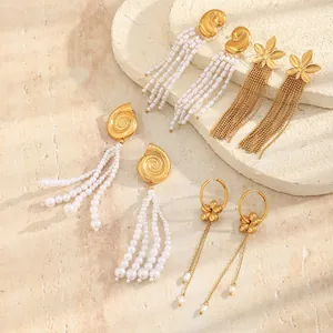Close-up detail of assorted Bohemian gold-plated earrings featuring pearls and tassels