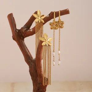 Detail of Bohemian 18K gold plated stainless steel floral earrings with pearl tassels