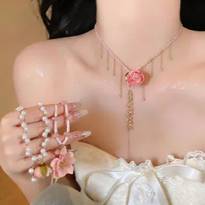Close-up of elegant pink flower pendant necklace with matching pearl bracelet set