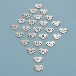 Detailed view of stainless steel heart charms with cut-out A-Z alphabet letters