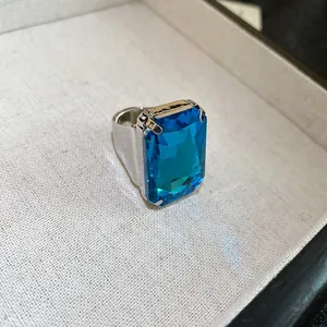 Retro silver ring featuring a large rectangular blue gemstone with exquisite facet details