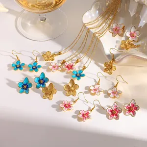 Detailed view of assorted enamel flower earrings and necklaces in 18k gold plating