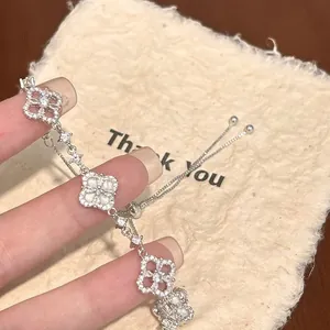 Close-up view of a sparkling zircon flower pendant bracelet with adjustable pull-string closure