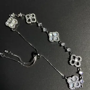 Detailed shot of an adjustable silver bracelet with zircon-encrusted flower motifs