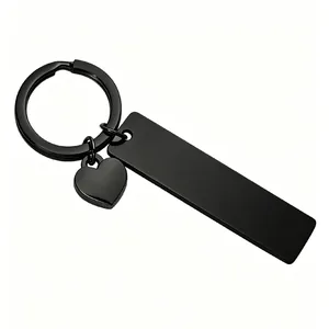 Close-up of a black stainless steel keychain with a rectangular plate and heart charm.