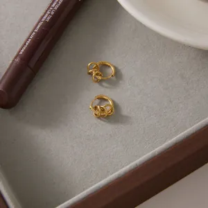 Detailed macro shot of elegant gold-toned multi-ring hoop earrings with shimmering zircons