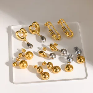 Close-up view of assorted two-tone 18K gold and silver stainless steel ball earrings